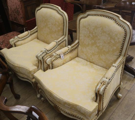 A pair of cream armchairs